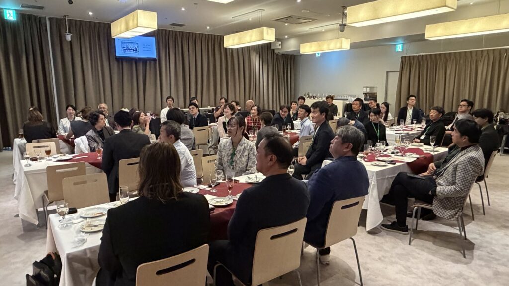 GSJ 6周年纪念派对的会场全景,与会者围坐圆桌,面向舞台聆听